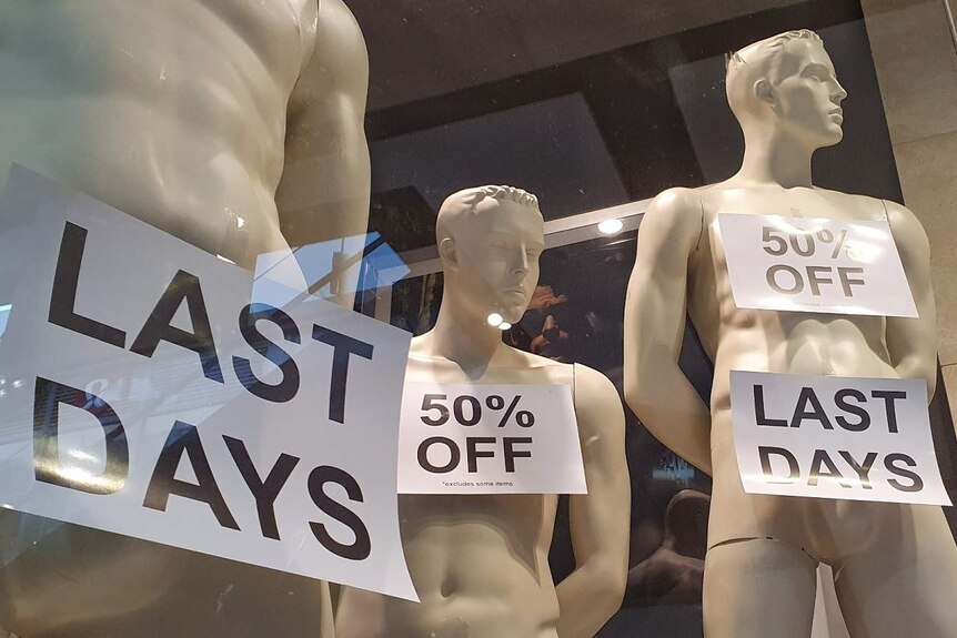 Mannequins with sale signs attached to them
