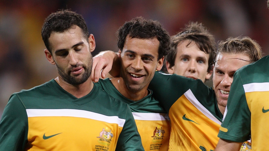 Game-saver ... Alex Brosque (c) celebrates kicking a late winner against Thailand.