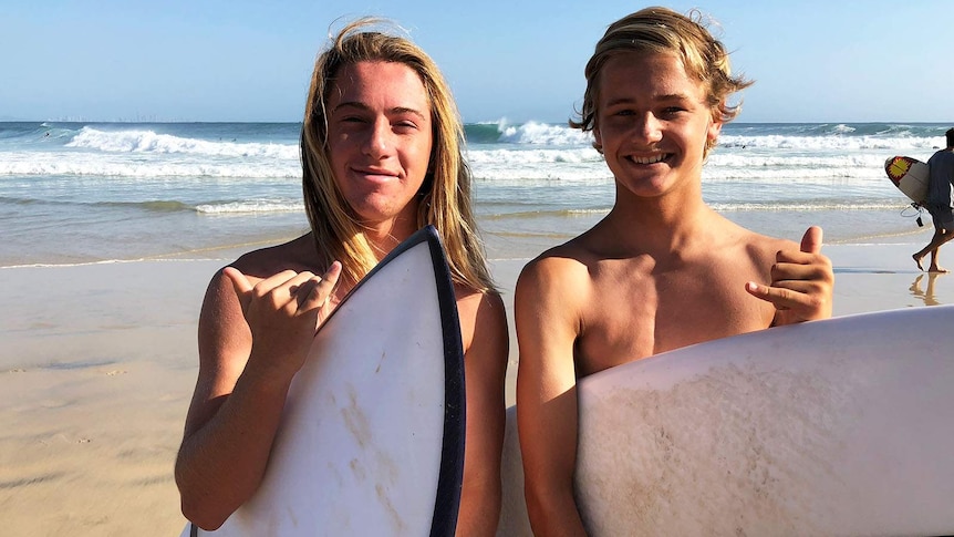 Surfers Nathan Hawker (L) and Brandon Feledyk at the water's edge at Snapper Rocks
