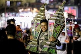 A man carries big lanterns called fanous to celebrate the month of Ramadan.