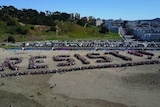 Aerial shot of protesters spelling out 'Resist' on a San Francisco beach.