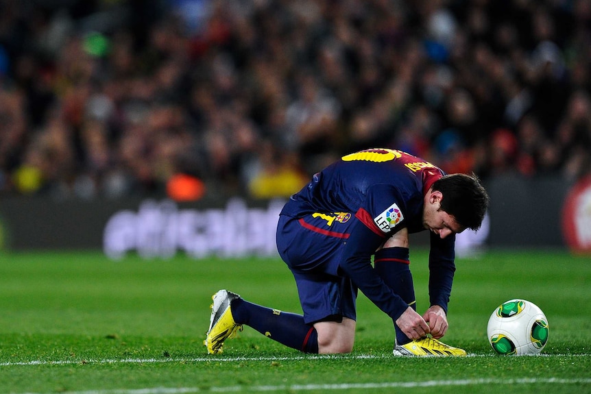 Lionel Messi laces up his boots