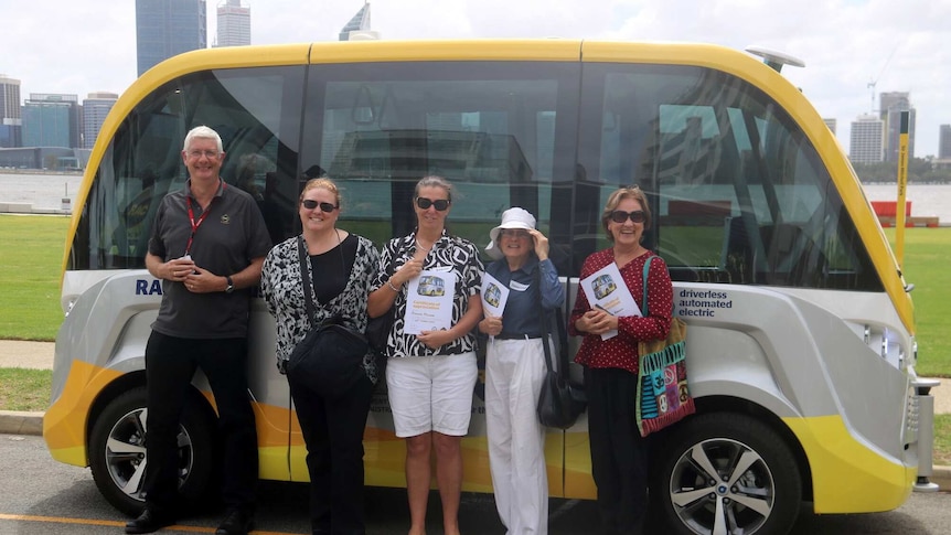 Five passengers stand alongside the RAC's driverless bus.