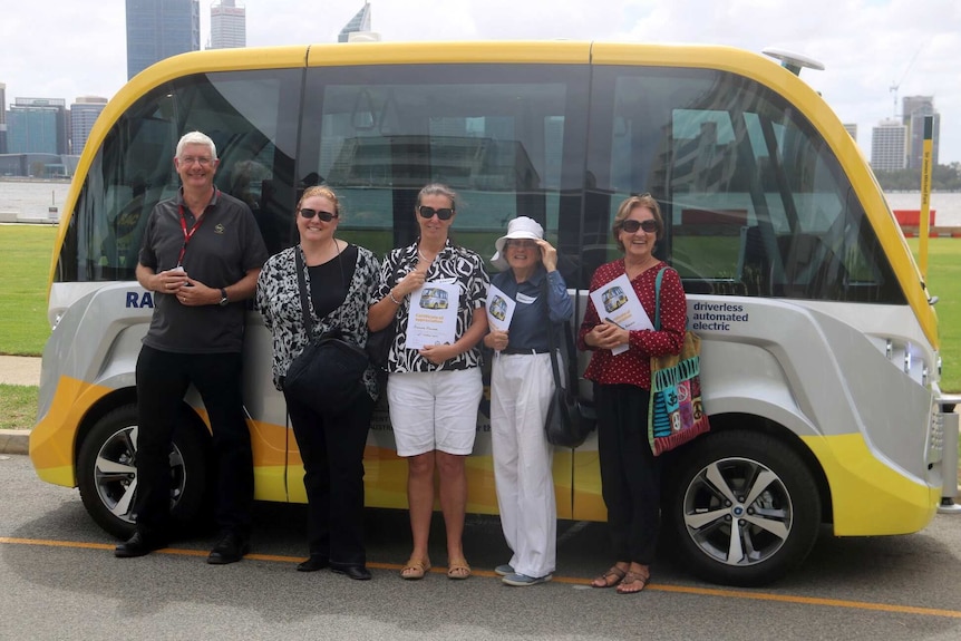 Five passengers stand alongside the RAC's driverless bus.