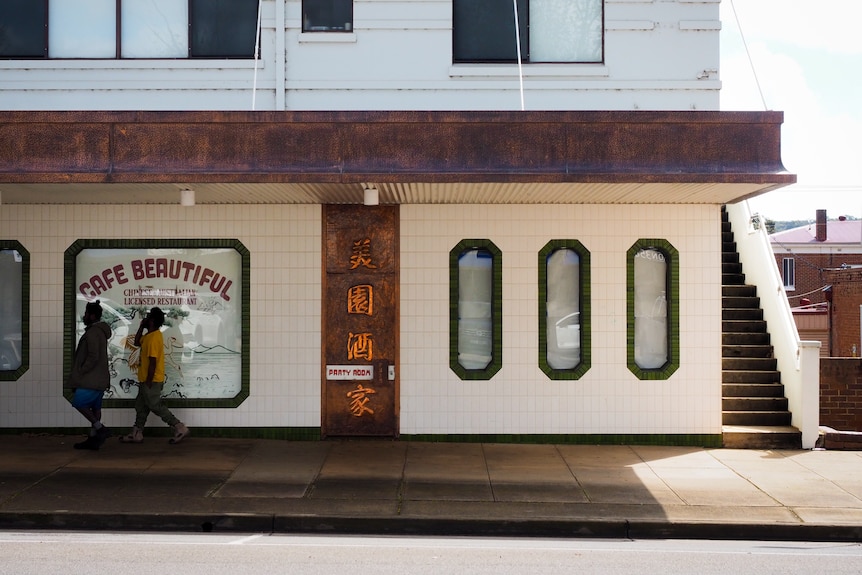 Two people walk past on the footpath outside Cafe Beautiful Chinese Restauant in Griffith