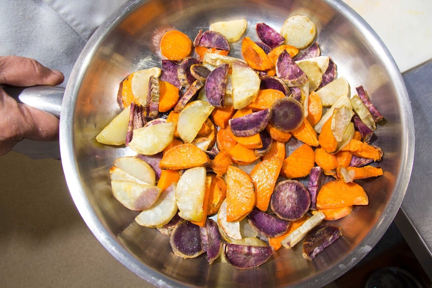 Mixed vegetables sit in a pan.