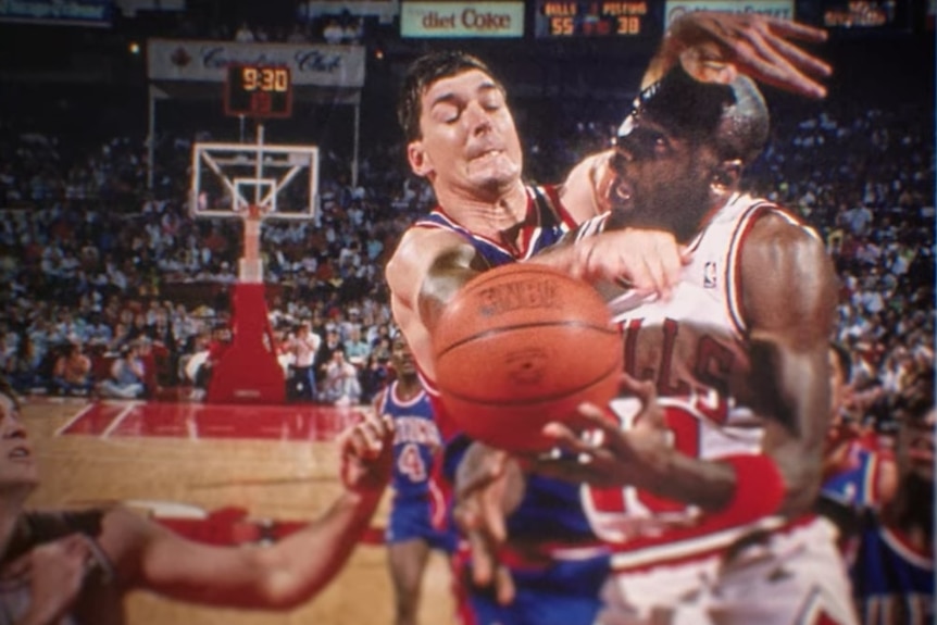 Detroit Pistons centre Bill Laimbeer hits Chicago Bulls star Michael Jordan with both arms during a game.