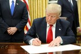 US President Donald Trump signs his first executive orders.