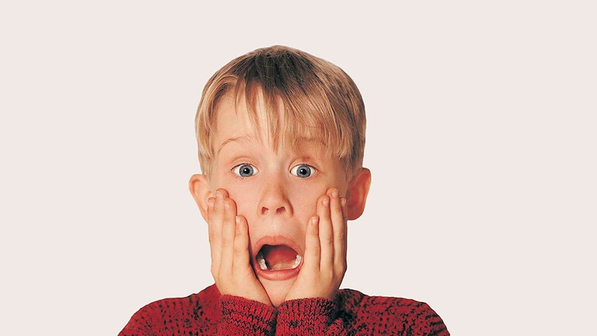Actor Macaulay Culkin from the movie Home Alone with his hands on his face while he goes, "Aaah!"