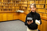Dr Matthew Brookhouse is examining samples at his university's wood library.