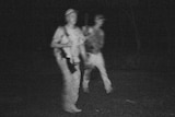 CCTV image of two men in caps carrying rifles