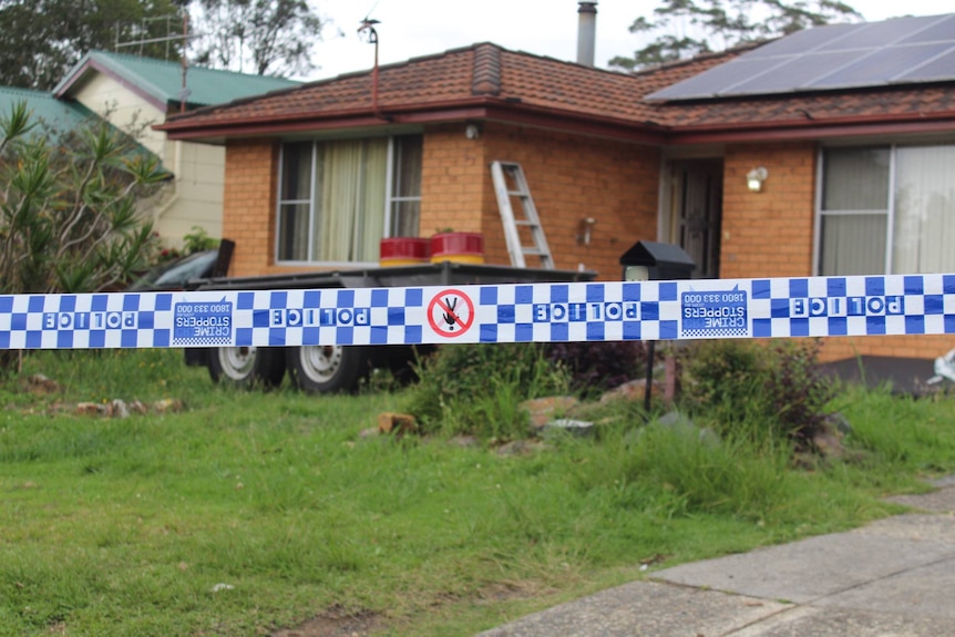 a home in kendall with blue and white police tape