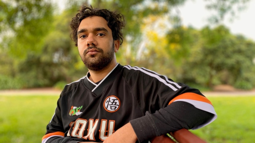 A man sits on a park bench.