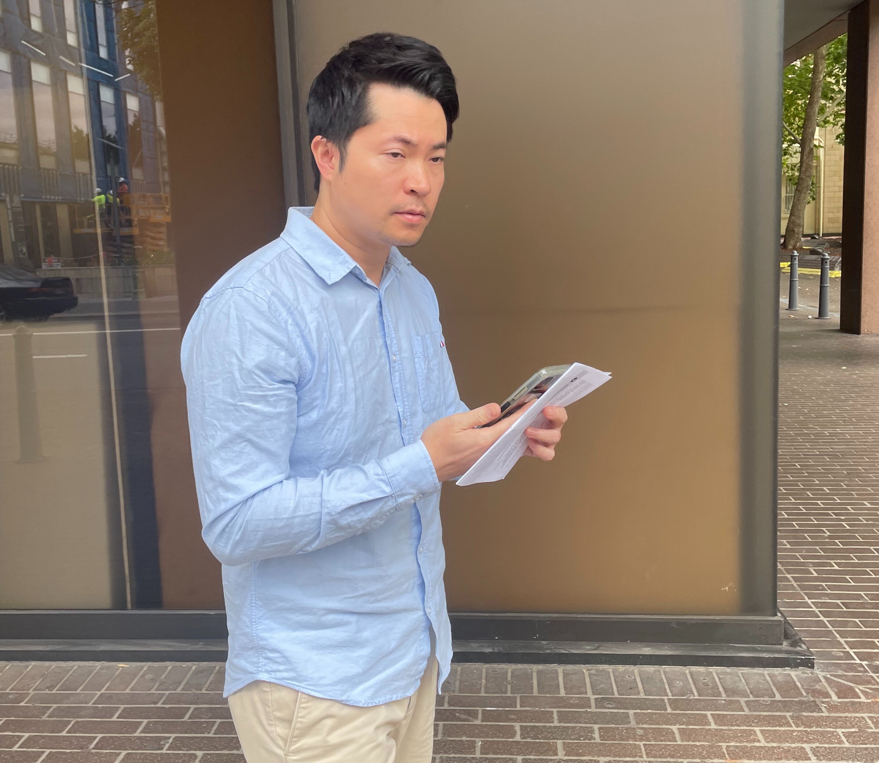 A man walks out of a building.