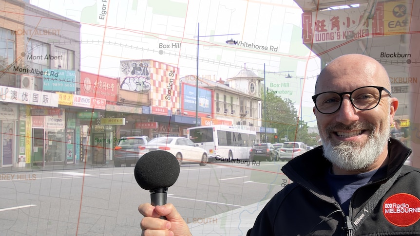 A composite image of Raf Epstein holding a mic in front of transparent map of Box Hill overlaid on a photo of a shopping strip.