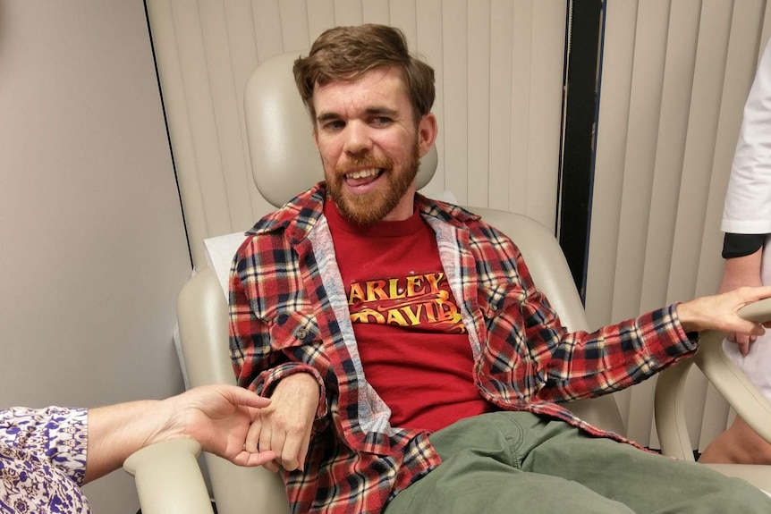 Jeremy Haines sits in the treatment room of Florida’s Institute of Neurological Recovery for his third injection.