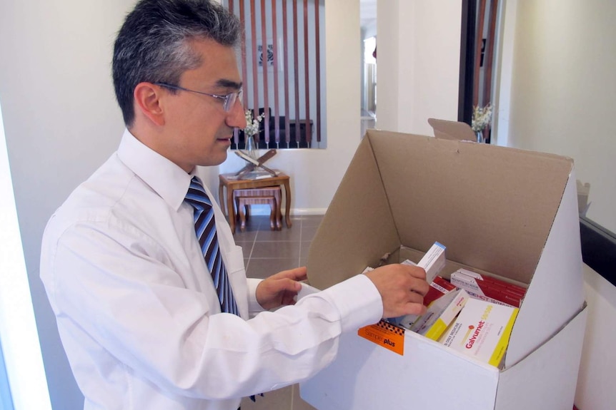 Dr Anas Natfaji checks medical supplies