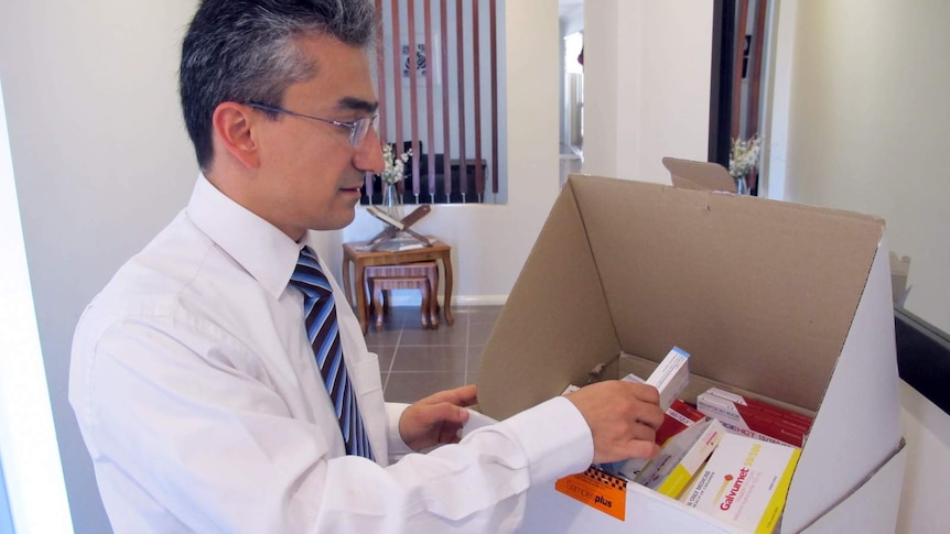 Dr Anas Natfaji checks medical supplies