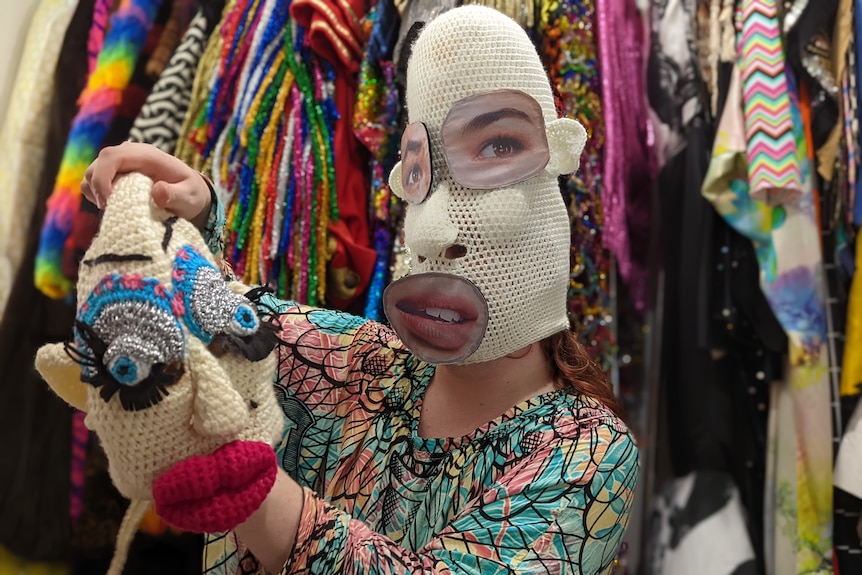 Ginava in a white crochet mask with realistic eyes and mouth stuck on