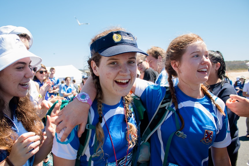 Two young women smile after finishing a race