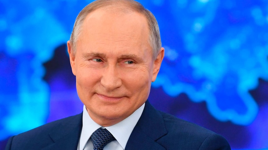 Russian President Vladimir Putin smiles