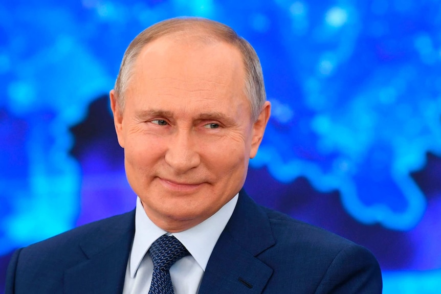 Russian President Vladimir Putin smiles