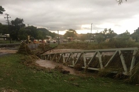 Floodwaters damaged this footbridge at Springsure in Central Queensland after more than 150mm of rain fell early this morning.