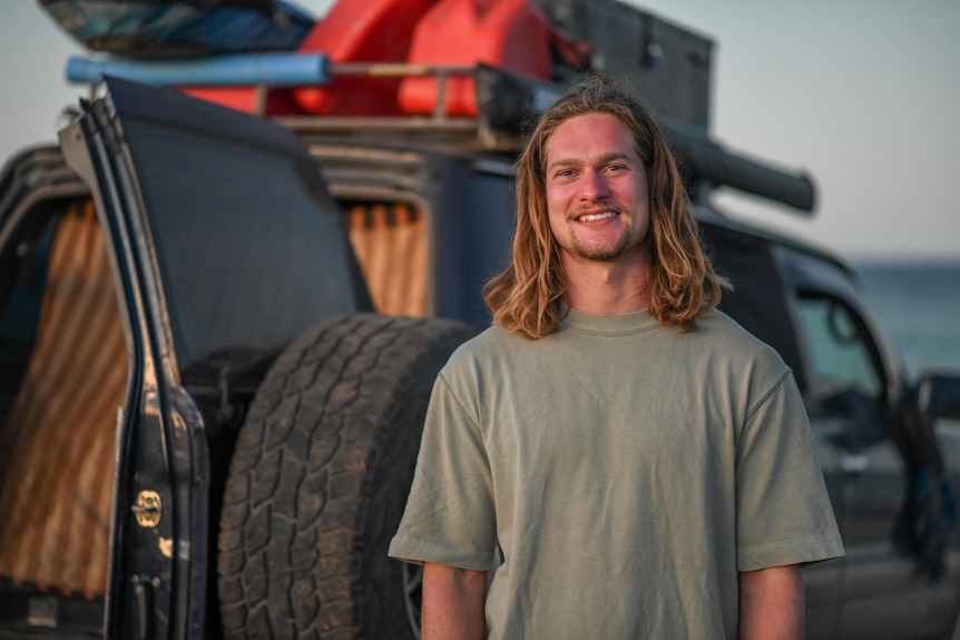 Man stands in front of a car