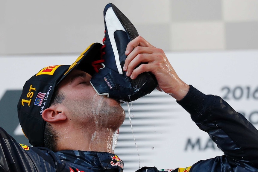 Red Bull driver Daniel Ricciardo drinks champagne from his shoe