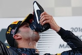 Red Bull driver Daniel Ricciardo drinks champagne from his shoe