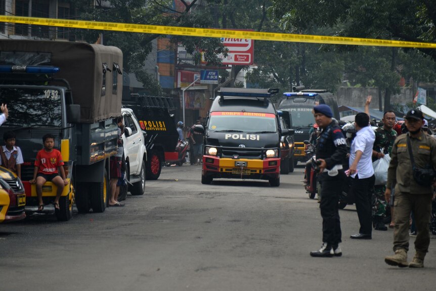 Policeman stands guard at the site of a blast at a police station in Bandung, West Java, Indonesia
