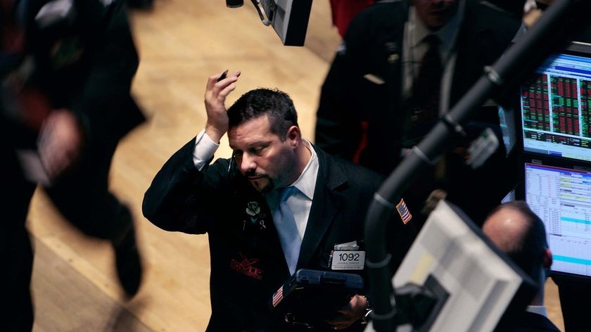 A trader reacts to the stock market figures on the floor of the New York Stock Exchange