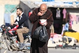 A man eats food that was distributed as aid in a rebel-held besieged area in Aleppo, Syria November 6, 2016.