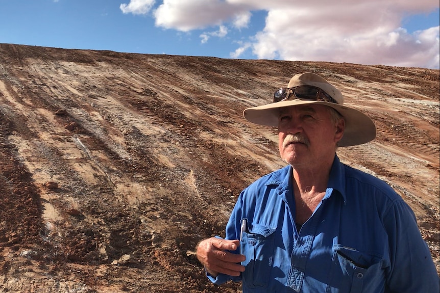 Grazier Richard Wilson looks at a cleaned-out dam on his property.
