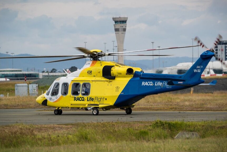 A LifeFlight helicopter on the tarmac of Brisbane Airport.