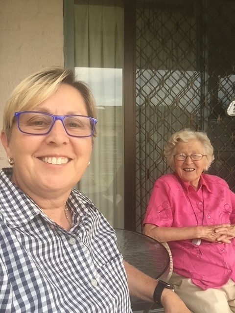 Woman sitting next to her elderly mother.