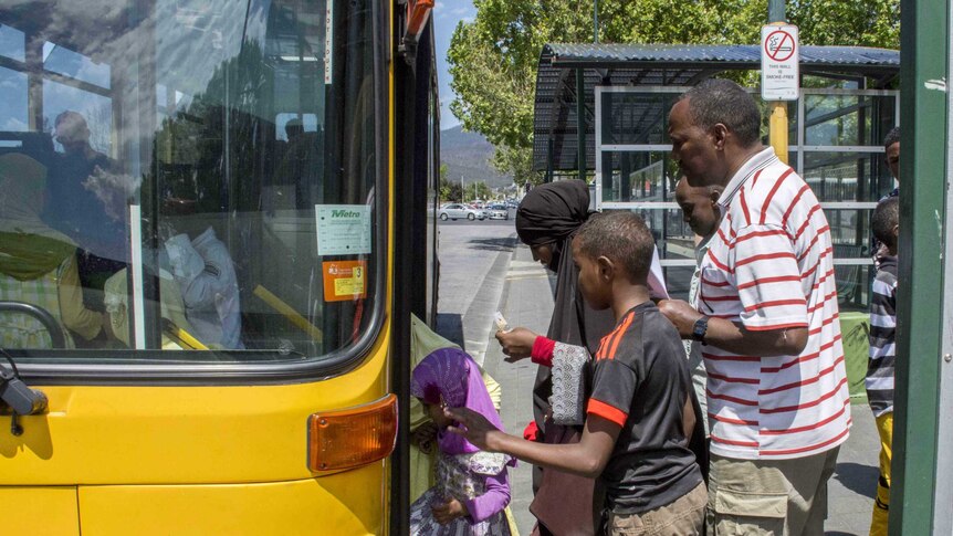 Ethiopians get on a bus in Hobart