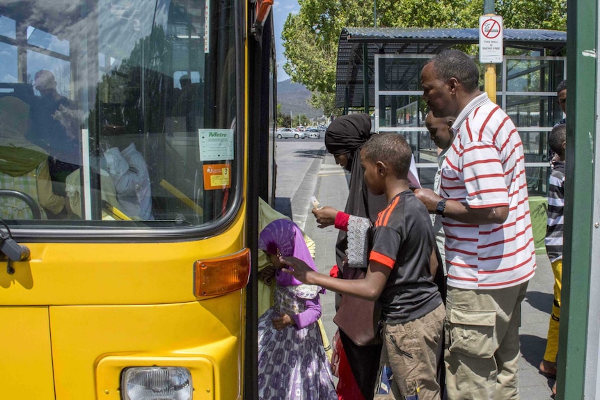 Ethiopians get on a bus in Hobart