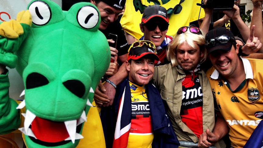 Cadel Evans celebrates with fans on the Champs-Elysees