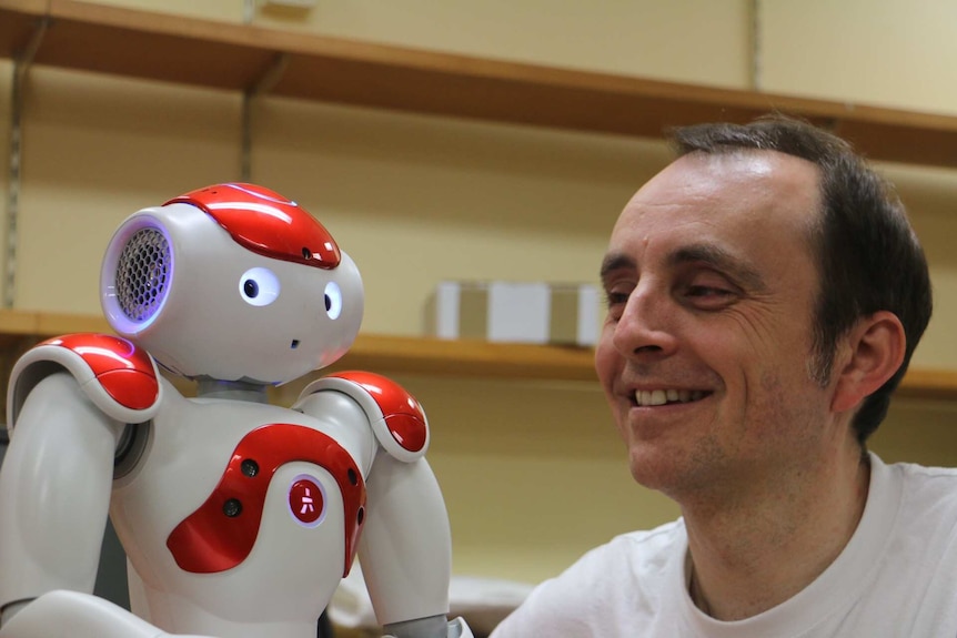 Professor Jonathan Roberts with a NAO robot