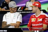 Lewis Hamilton (L) talks to Sebastian Vettel at a press conference ahead of 2016 US F1 grand prix.