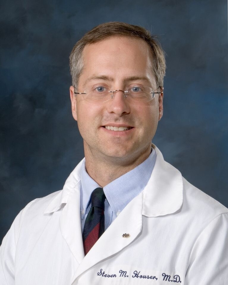 A smiling doctor in a white coat.