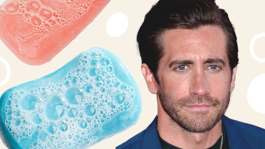 Jake Gyllenhaal stares straight ahead and smizes on the right of a composite image with pink and blue suddy soap on the left.