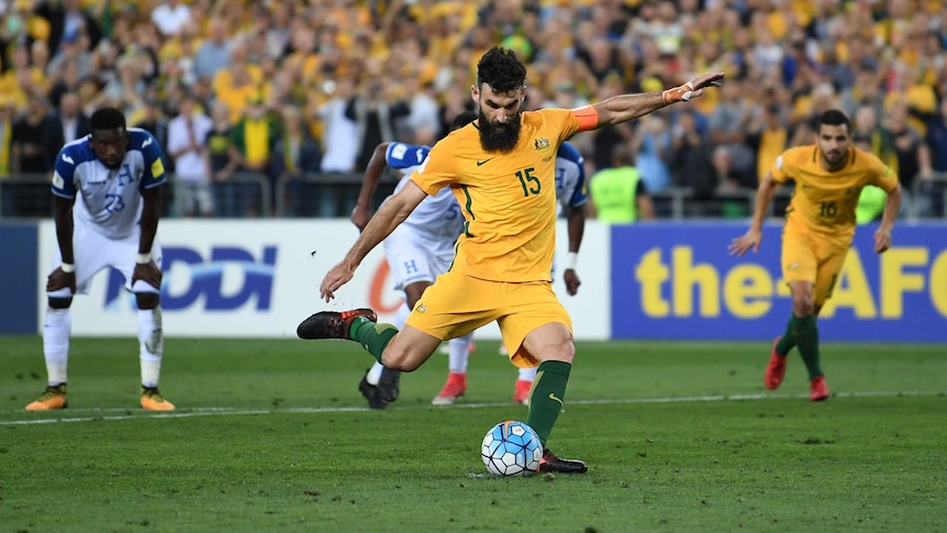 Socceroos' Mile Jedinak slots home a penalty against Honduras