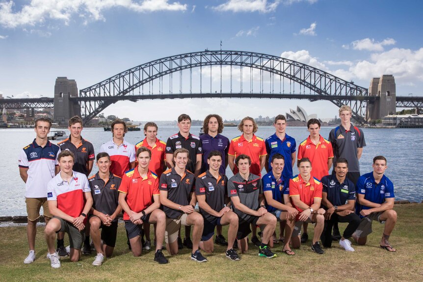 The top draft picks from the 2016 AFL draft pose for a group photo in front of the Sydney Harbour Bridge.