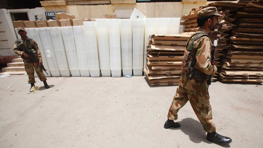 Soldiers guard election ballot boxes ahead of today's election.
