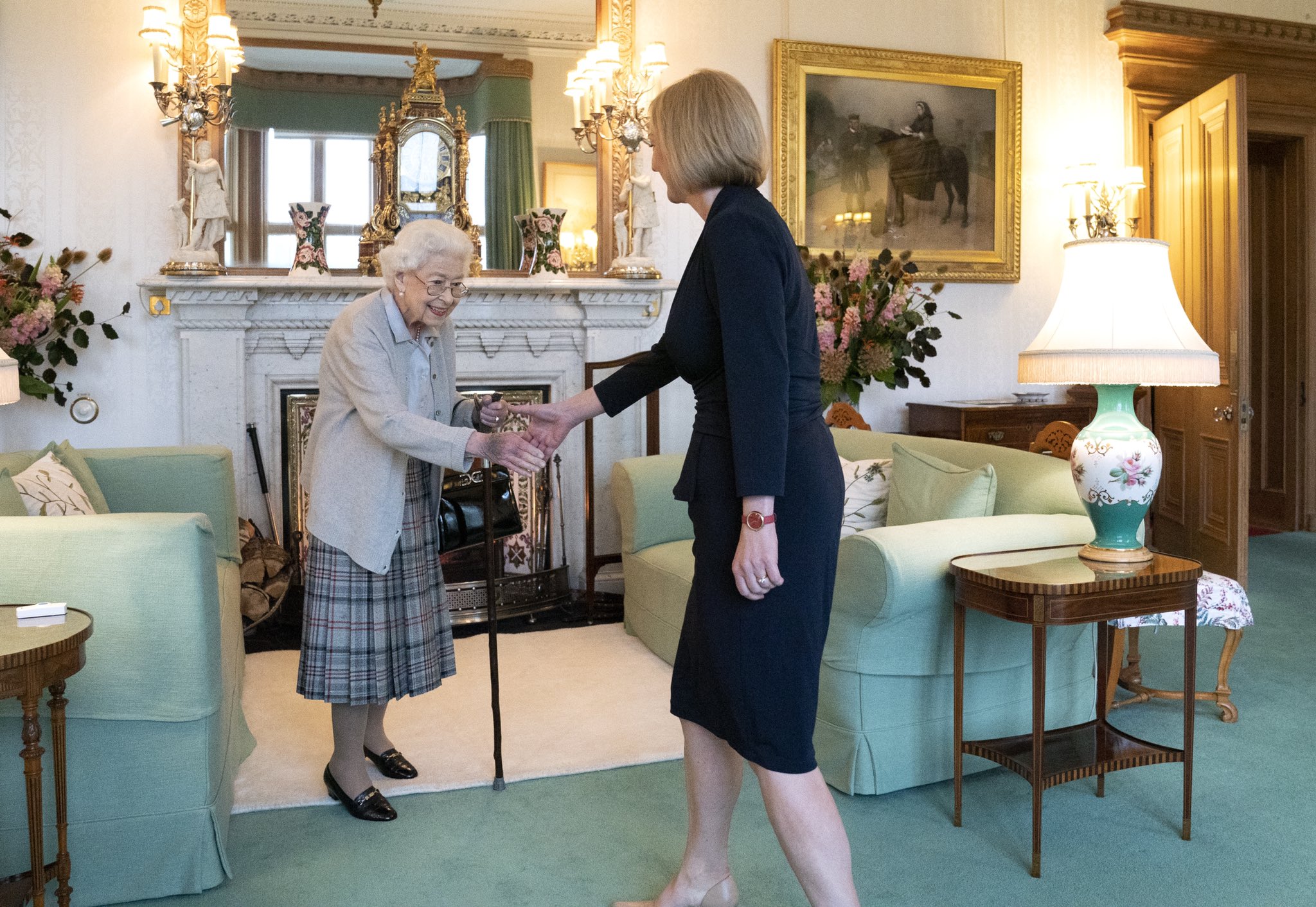Queen Elizabeth II meets Liz Truss. The Queen is using a walking cane.