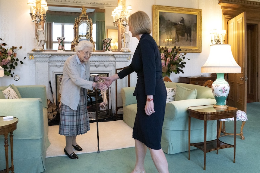 Queen Elizabeth II meets Liz Truss. The Queen is using a walking cane.