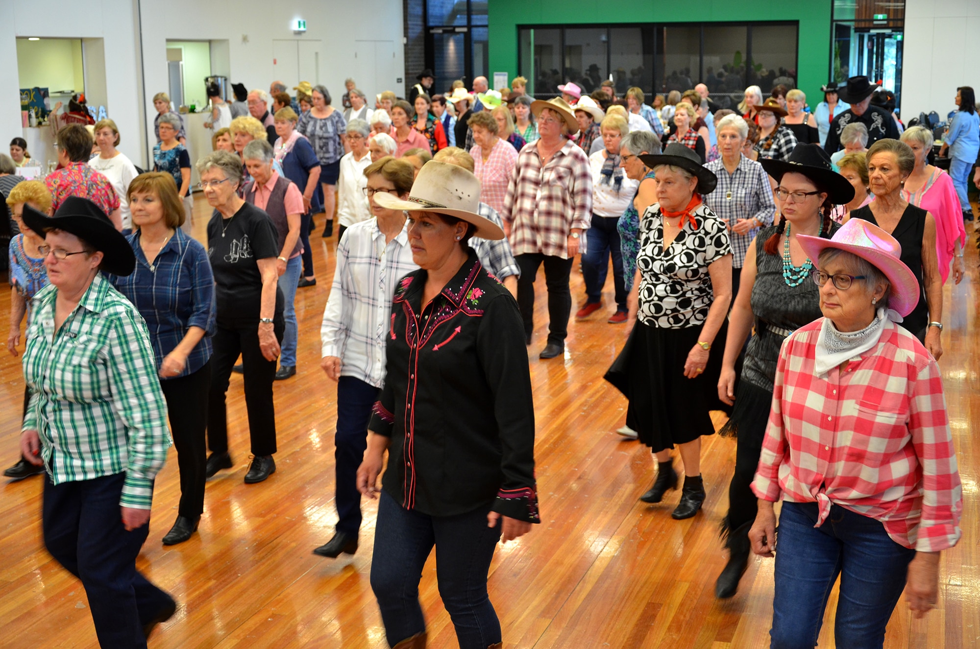 Un grupo de personas con sombreros de vaquero en un auditorio.