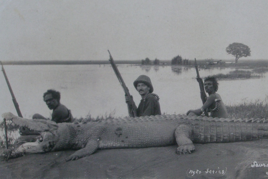 Ryko posing with tribesmen and crocodile.